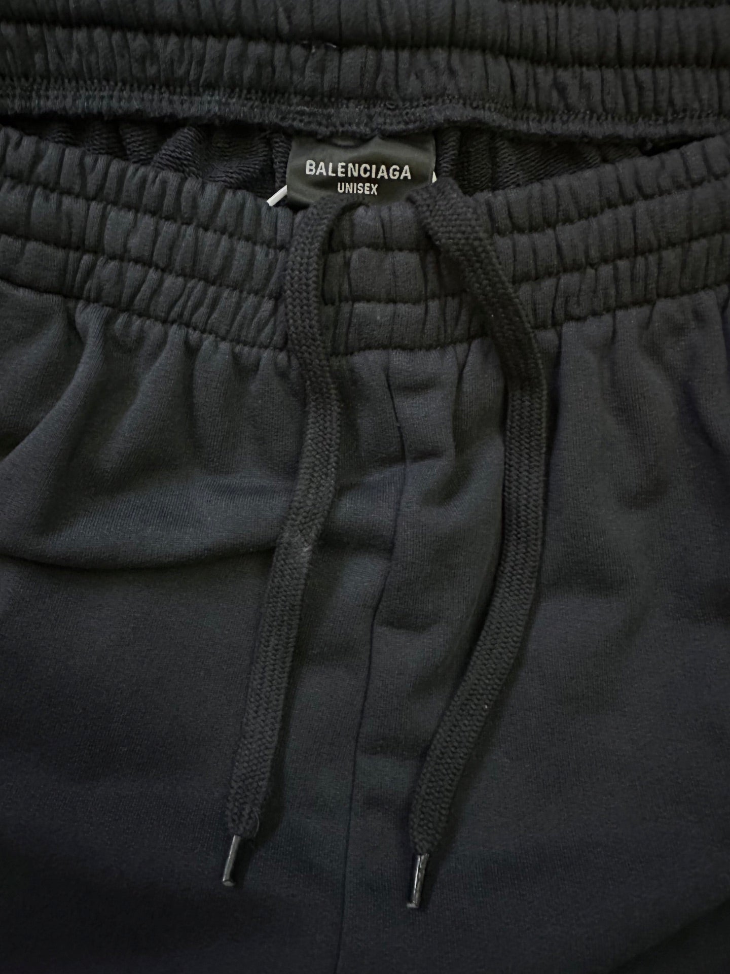 Black elastic-waist shorts with drawstring ties and Balenciaga Unisex label