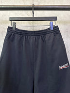 Black elastic-waist shorts with drawstring and Balenciaga side logo