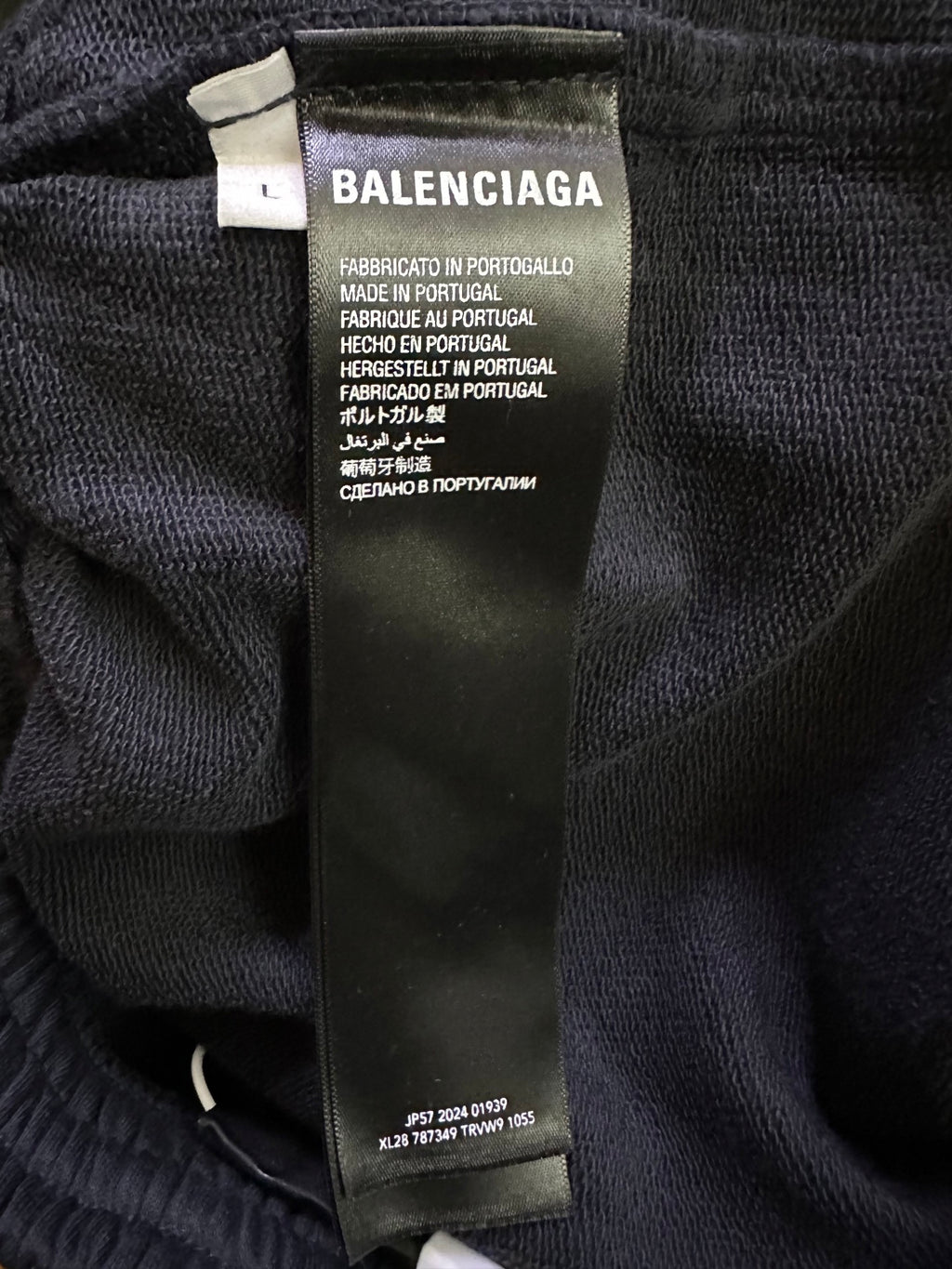 Black shorts with fabric care label showing Balenciaga logo and Made in Portugal