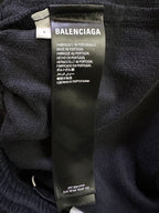Black shorts with fabric care label showing Balenciaga logo and Made in Portugal
