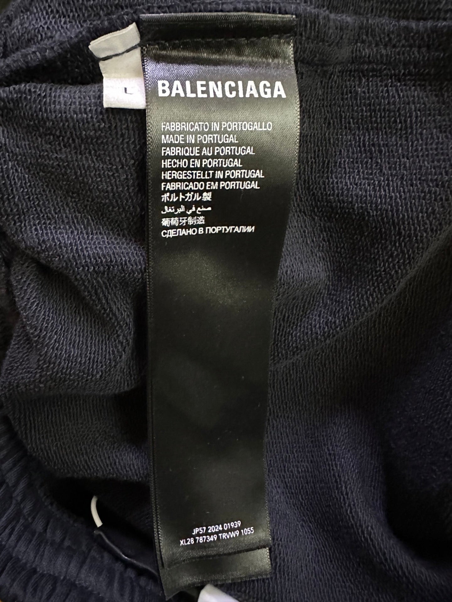 Black shorts with fabric care label showing Balenciaga logo and Made in Portugal