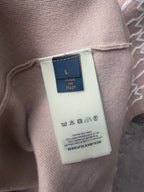 Beige T-shirt size tag showing size “L” with inside care label near neck