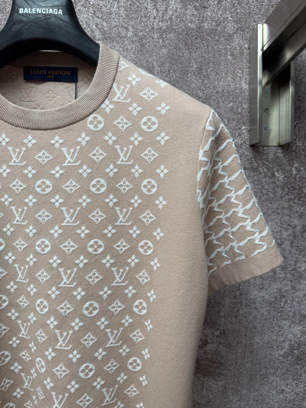 Light beige logo-print T-shirt close-up with ribbed crew neckline and short sleeves