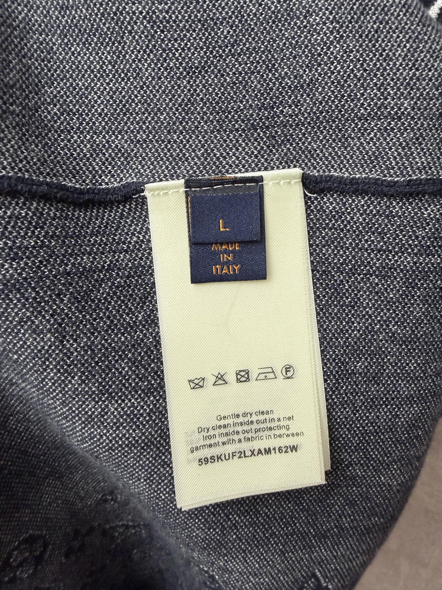Louis Vuitton inner neck label on navy T-shirt, fabric tag and care info close-up