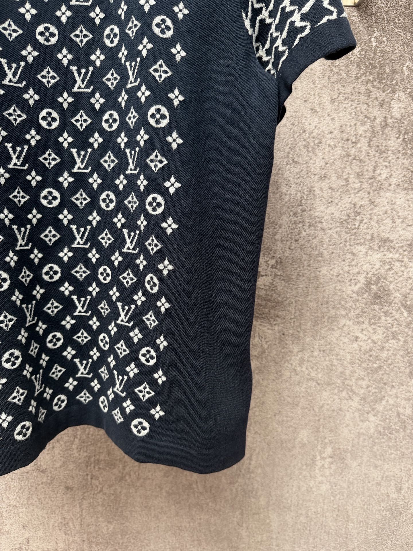 Louis Vuitton logo T-shirt fabric close-up, dark navy knit with white monogram pattern