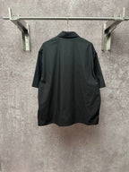 Short-sleeve button-up shirt, dark back view with straight hem and yoke seam