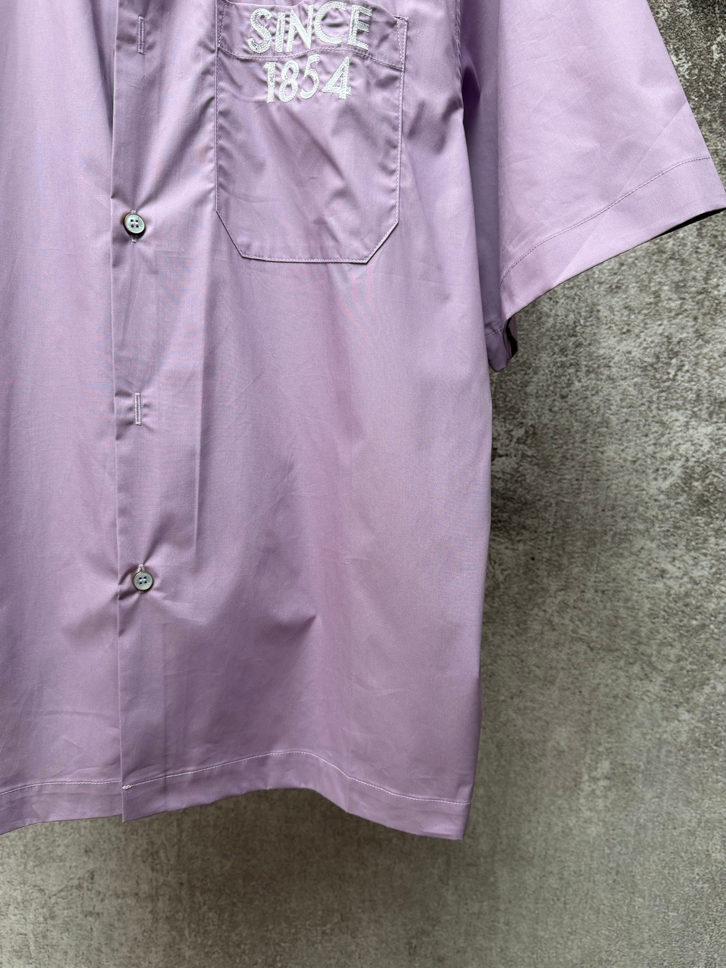 Men's short-sleeve button-up shirt in lavender, front with button placket