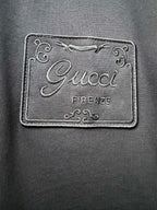 Embroidered Gucci Firenze logo label patch on dark fabric