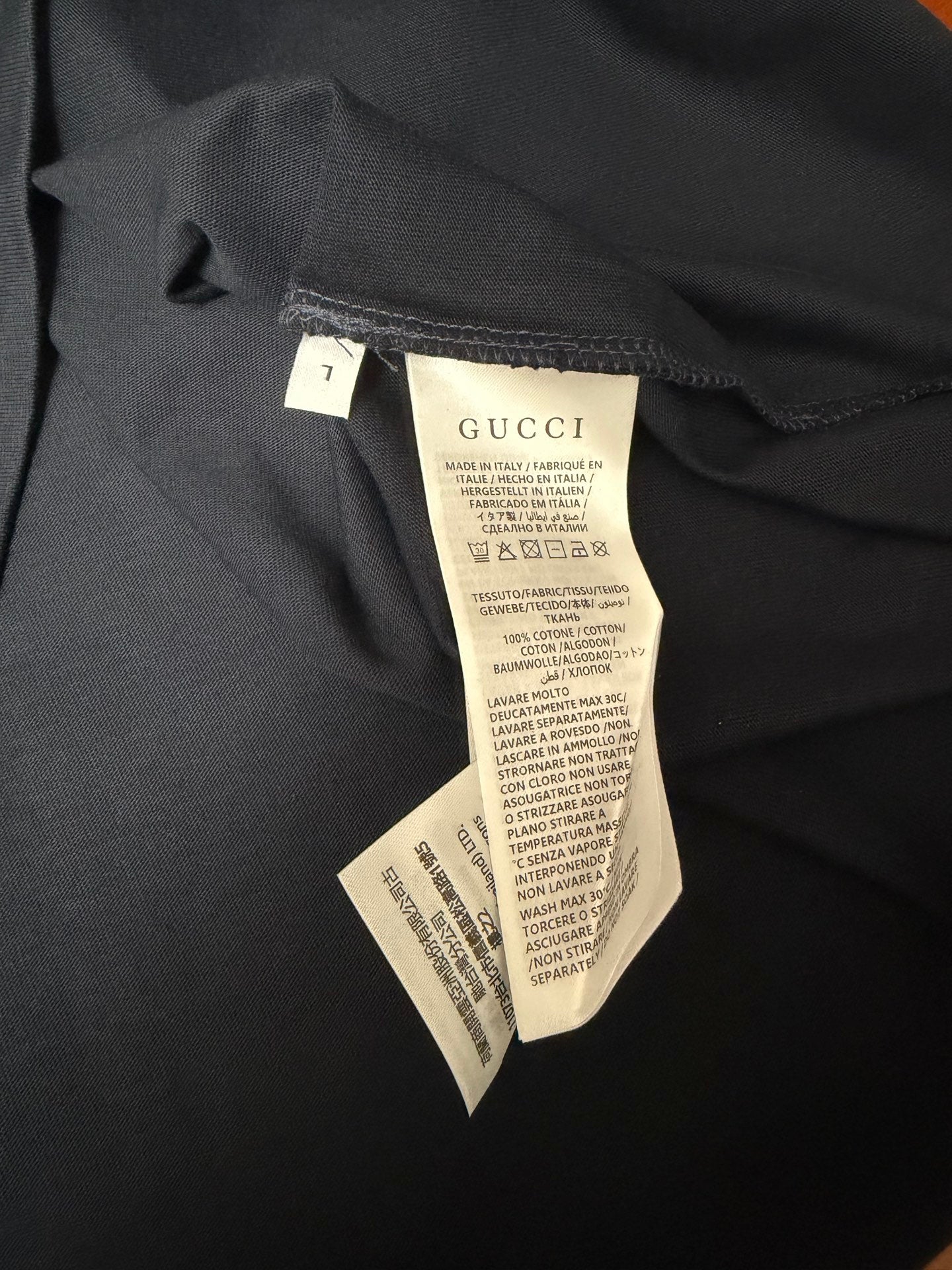 Dark navy T-shirt inner care labels on fabric near side seam