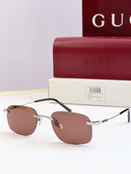 Sunglasses with gold-tone metal frame and brown tinted lenses, thin arms