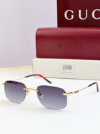 Sunglasses with gold-tone frame, dark lenses, multicolor detail on temple tips
