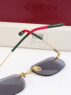 Sunglasses side view, red and green temple arms with gold-tone frame and dark lenses