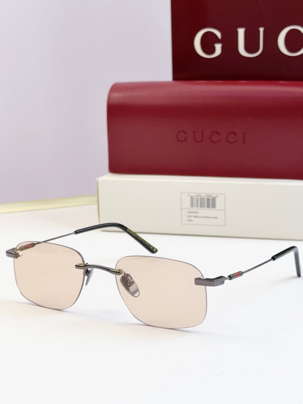 Sunglasses with gold-tone frame and light tinted lenses, slim arms with accents