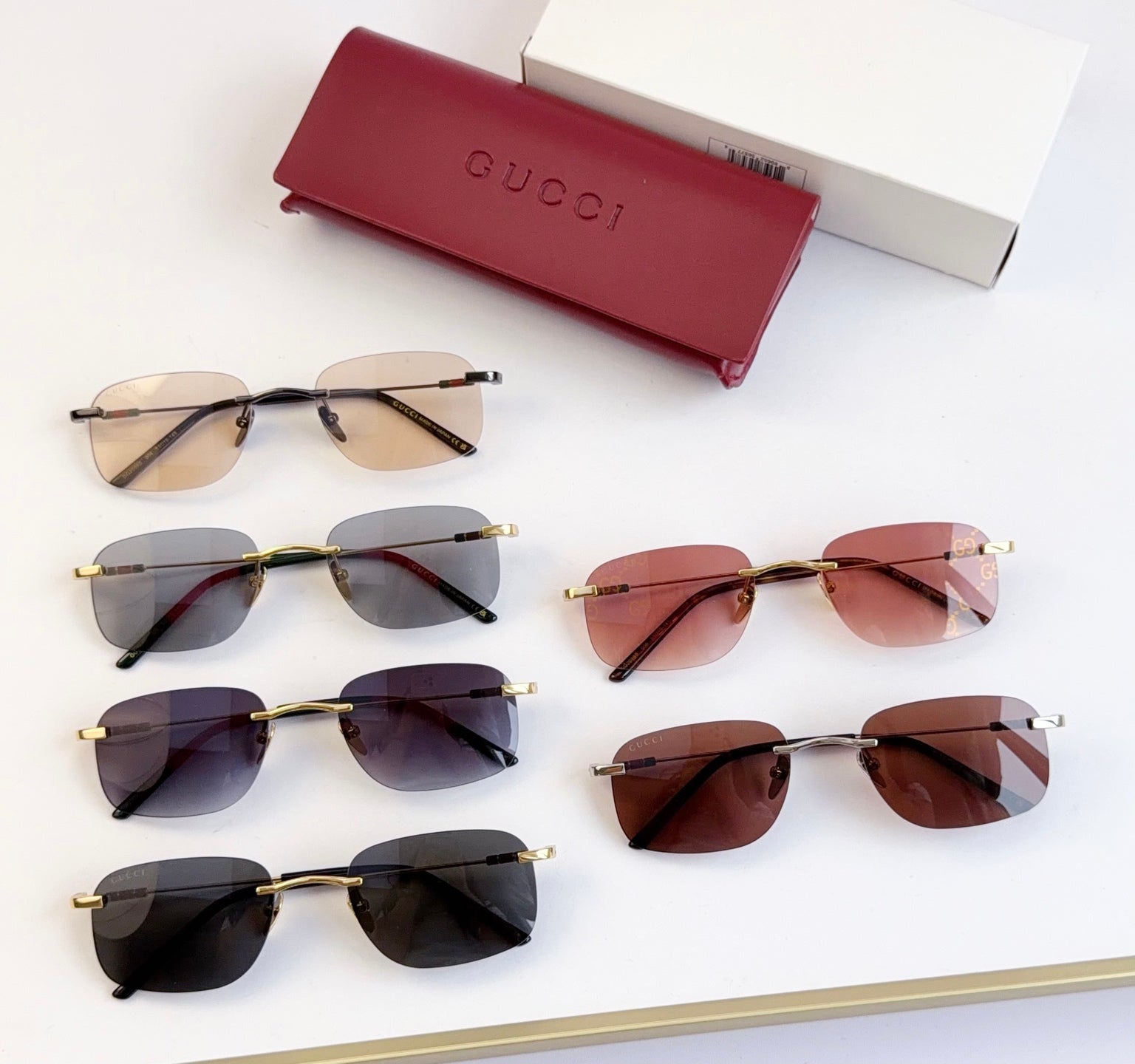 Assorted sunglasses display, gold-tone frames with tinted lenses in multiple colors