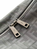 Fendi logo fabric bag close-up with double zippers and metal pull tabs