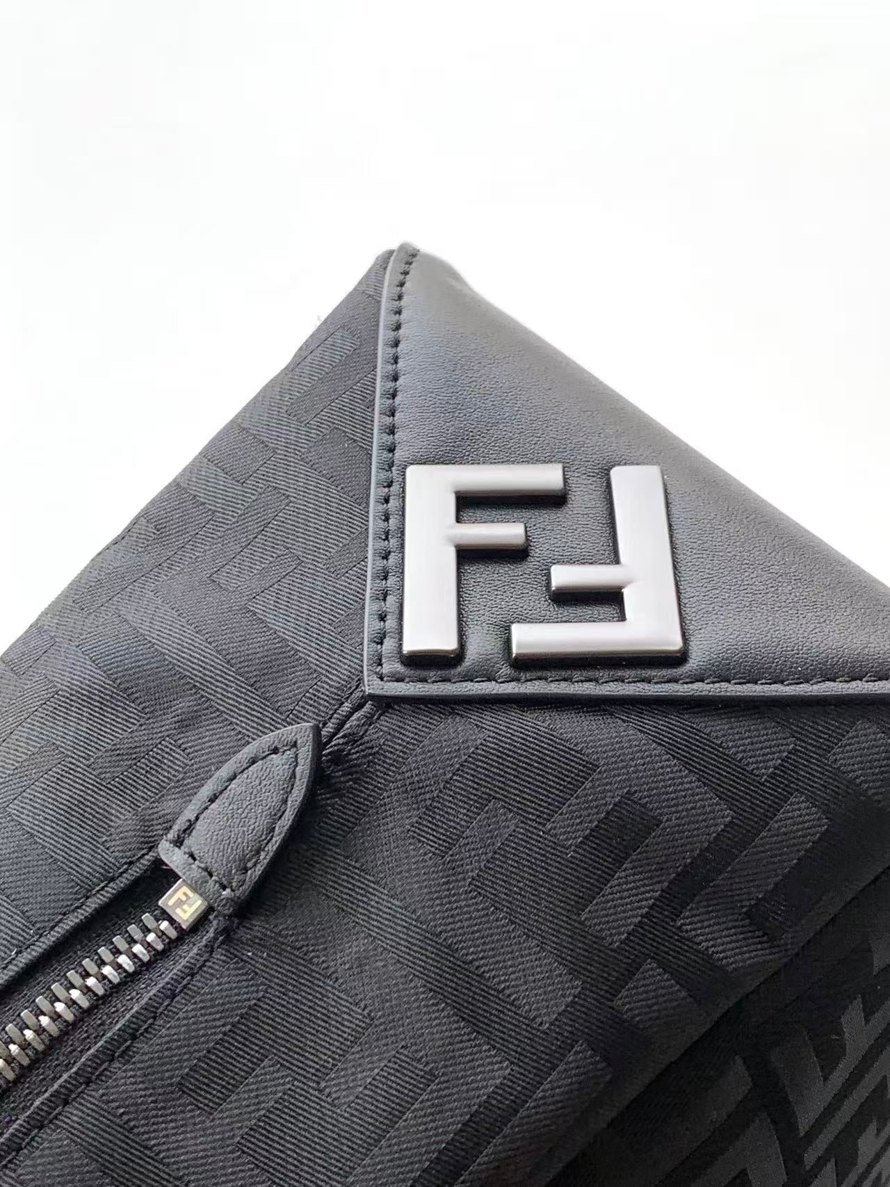 Fendi FF logo patch on dark patterned bag with zipper edge detail