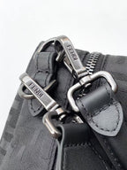 Fendi bag hardware close-up with metal clips, buckles, and logo label