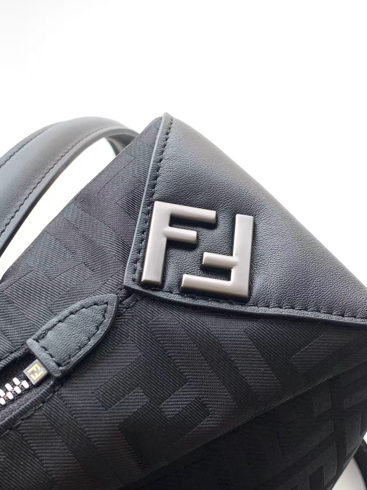 Fendi bag close-up of FF logo in silver on textured gray fabric