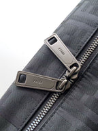 Fendi bag zipper pulls with silver hardware on gray textured fabric