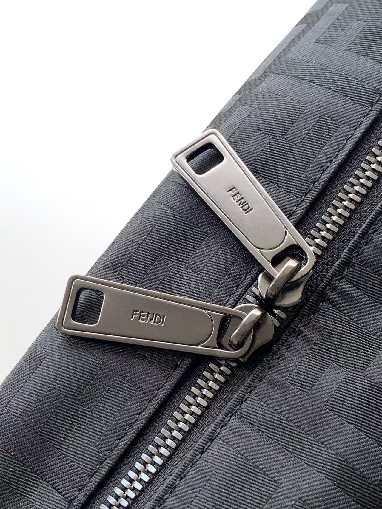 Fendi bag zipper pulls with silver hardware on gray textured fabric