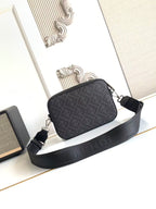 Logo crossbody bag with textured finish, top zip, and wide black strap.