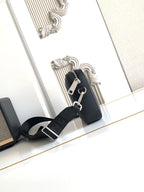 Logo crossbody bag with silver hardware, top zip, and adjustable shoulder strap.