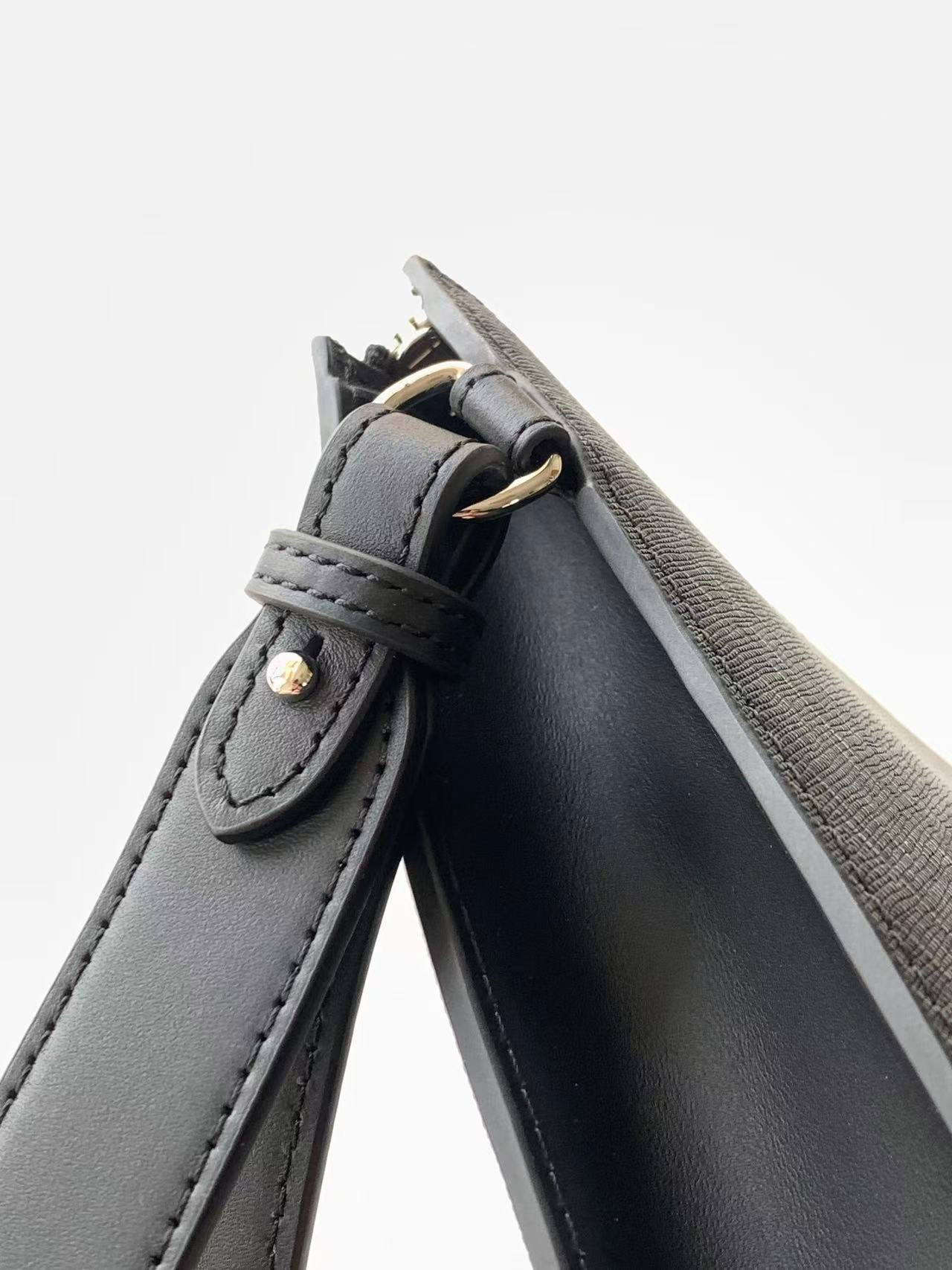Fendi bag corner close-up with leather loop and gold-toned button hardware.