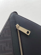 Fendi bag zipper close-up with metal pull tab and dark leather trim along the edge.