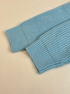 Light blue ribbed knit cuff detail on a Louis Vuitton sweater sleeve