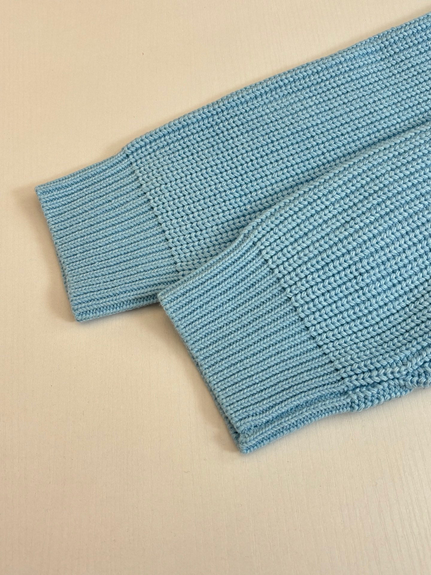 Light blue ribbed knit cuff detail on a Louis Vuitton sweater sleeve