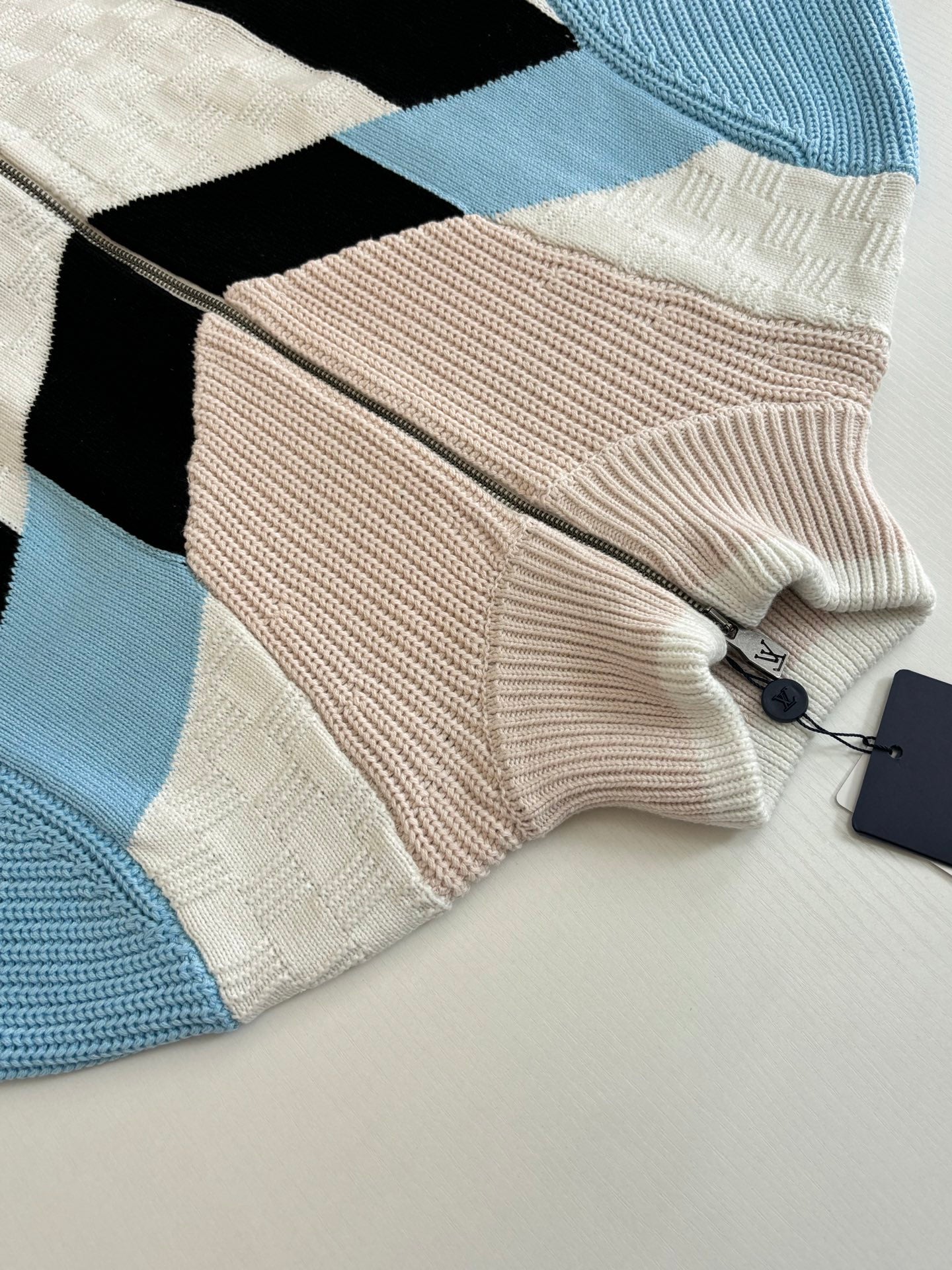 Louis Vuitton knit zip sweater folded detail with cream knit, black panel, and light blue trim