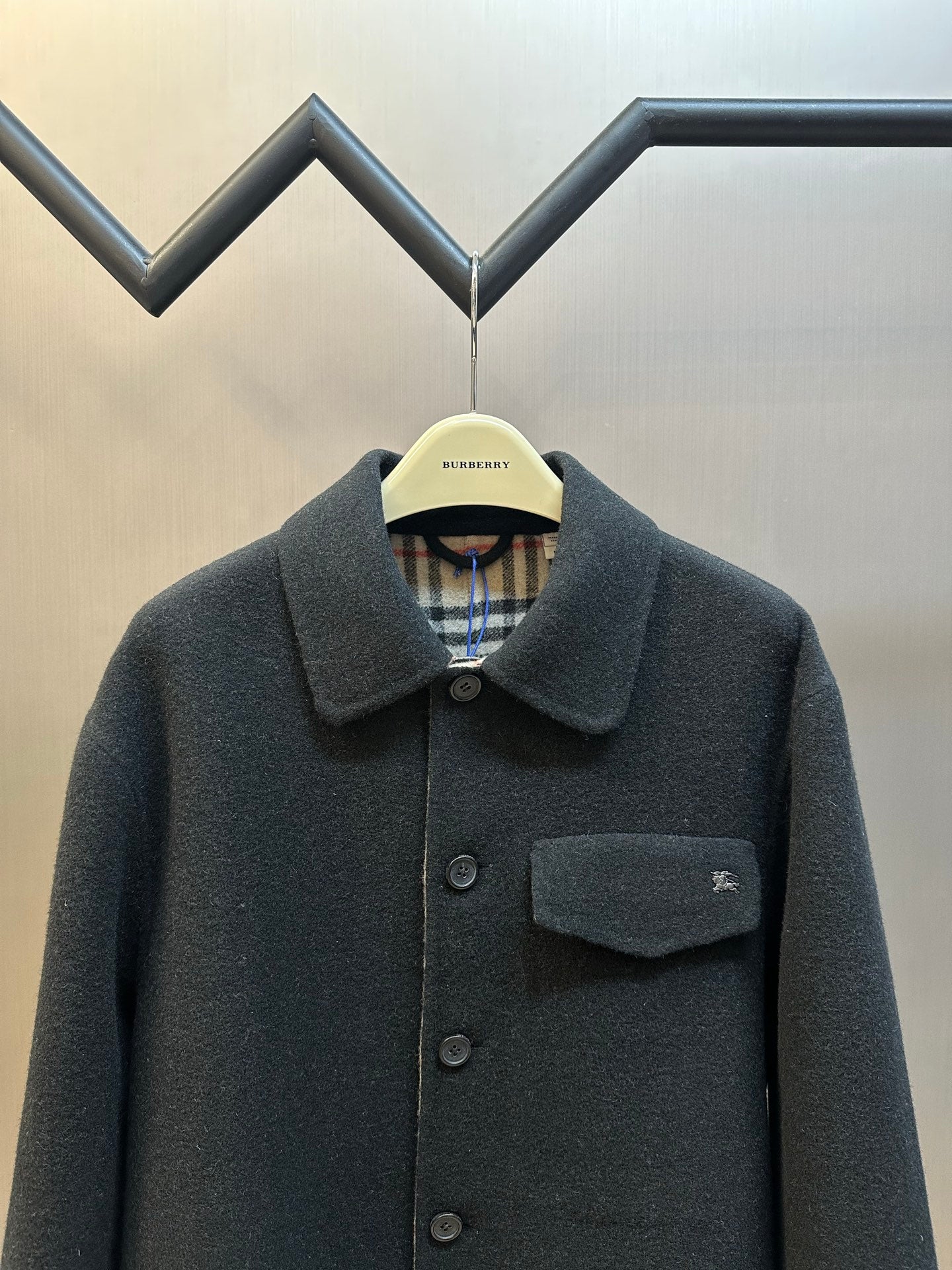 Burberry long-sleeve coat with chest pocket, dark buttons, and pointed collar