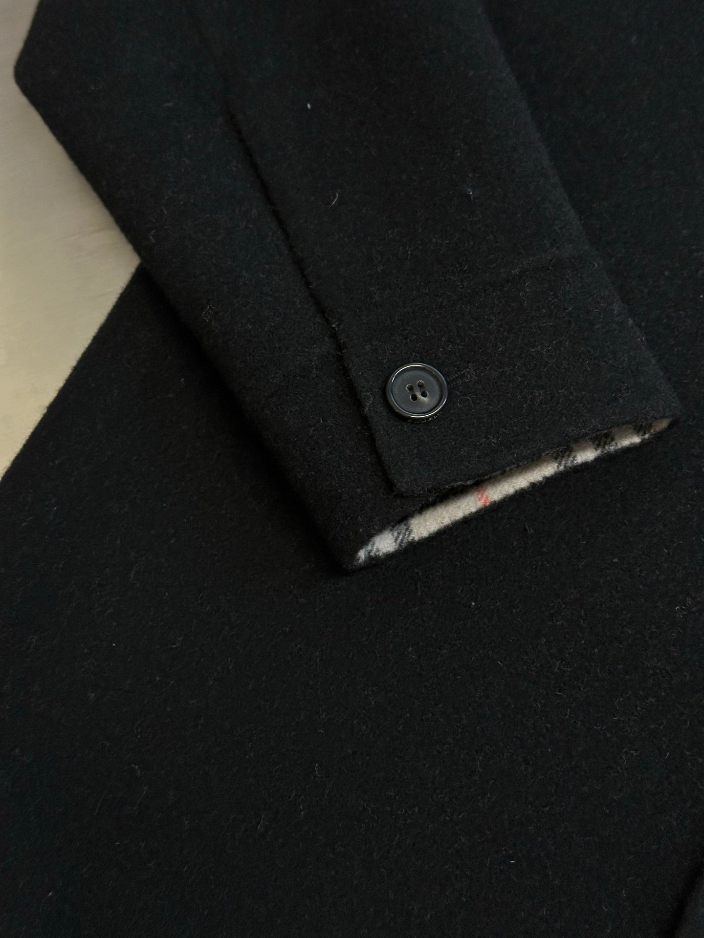 Burberry coat sleeve cuff with button and plaid inner trim