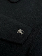Burberry coat chest logo patch on dark fabric