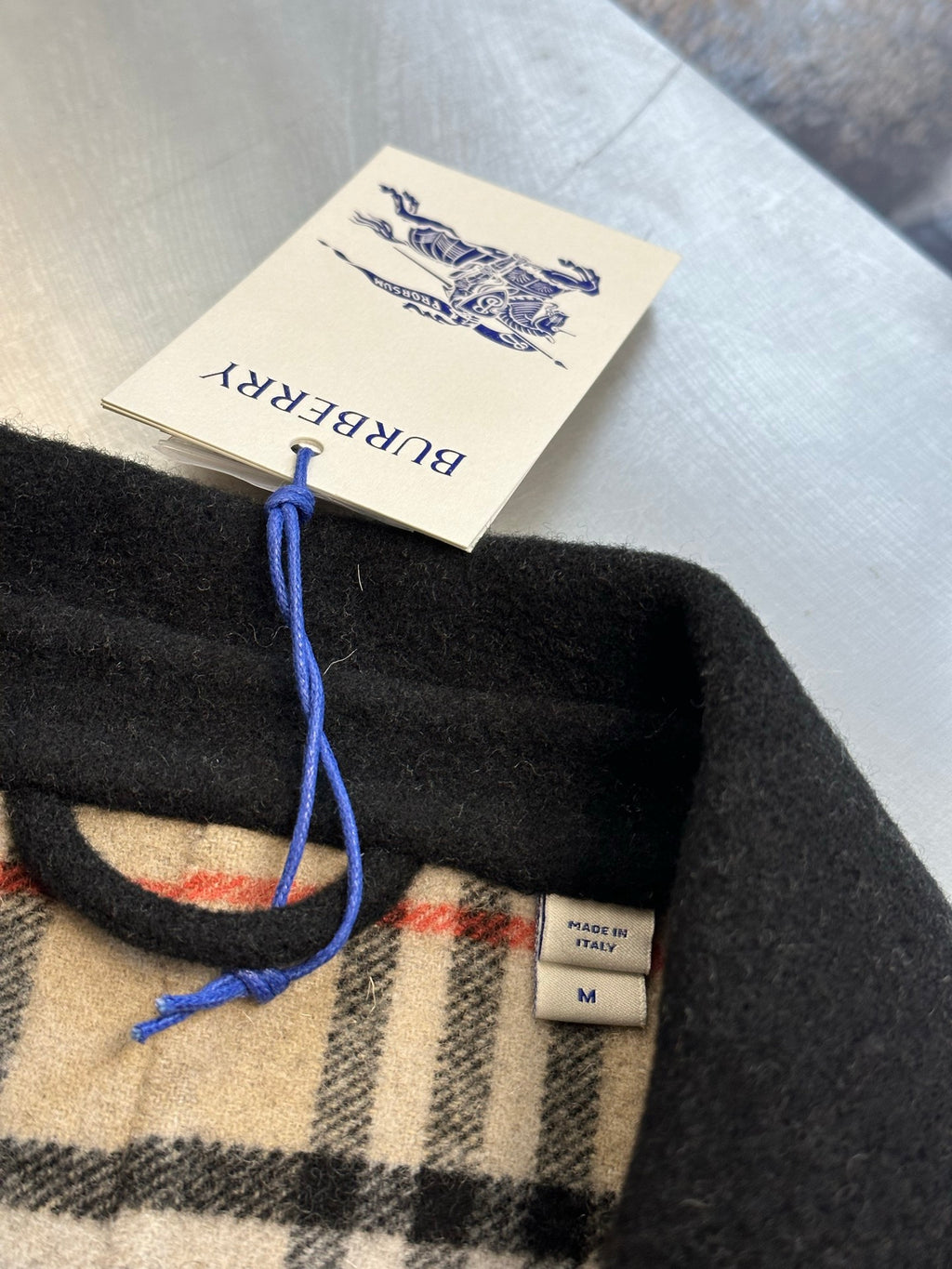 Burberry coat tag and plaid lining with size label