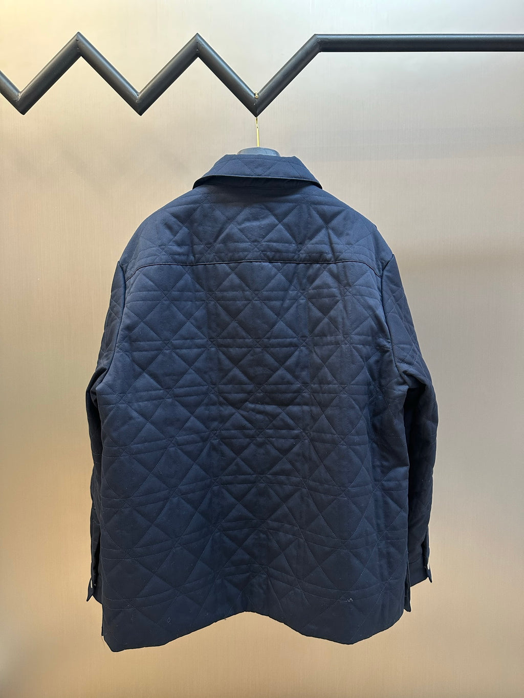 Quilted long jacket back view in dark navy with raised collar