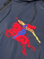 Navy jacket front with red, blue, and yellow embroidered cat graphic