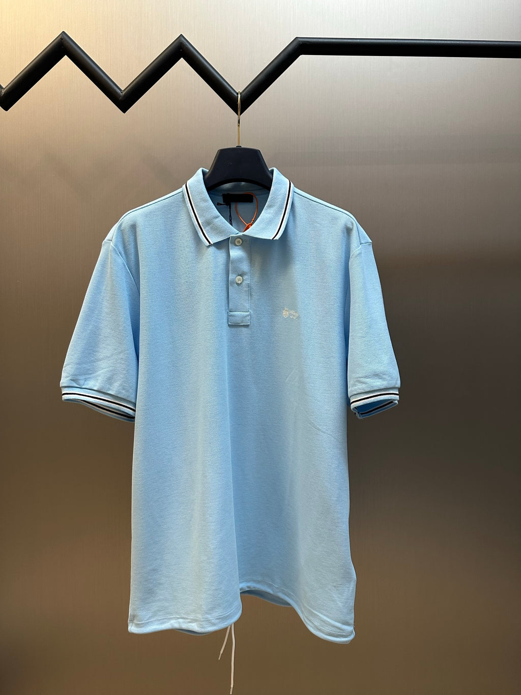 Prada light blue polo shirt on hanger, short sleeves and button placket