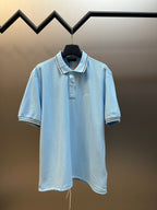 Prada light blue polo shirt on hanger, short sleeves and button placket