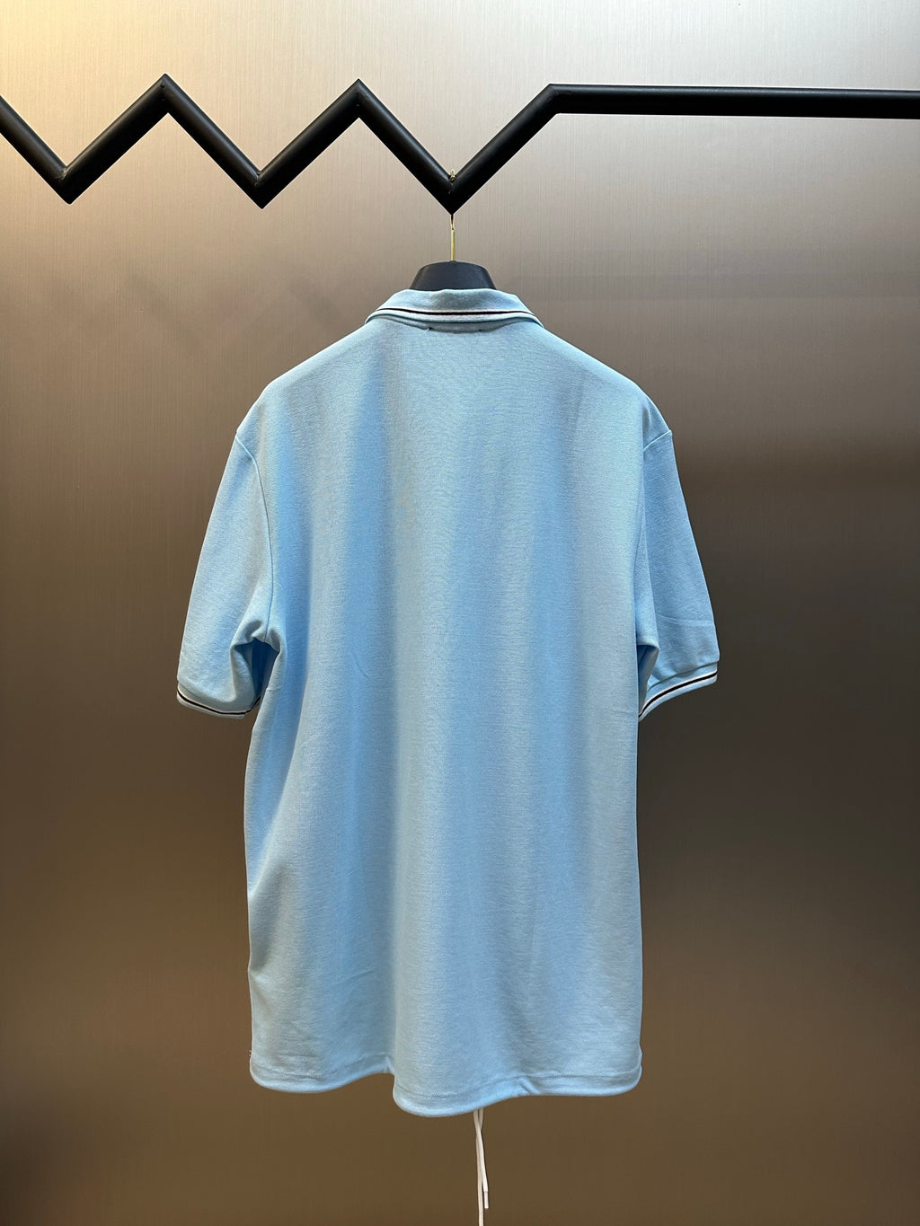 Prada light blue polo shirt back view with striped collar trim