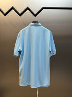 Prada light blue polo shirt back view with striped collar trim