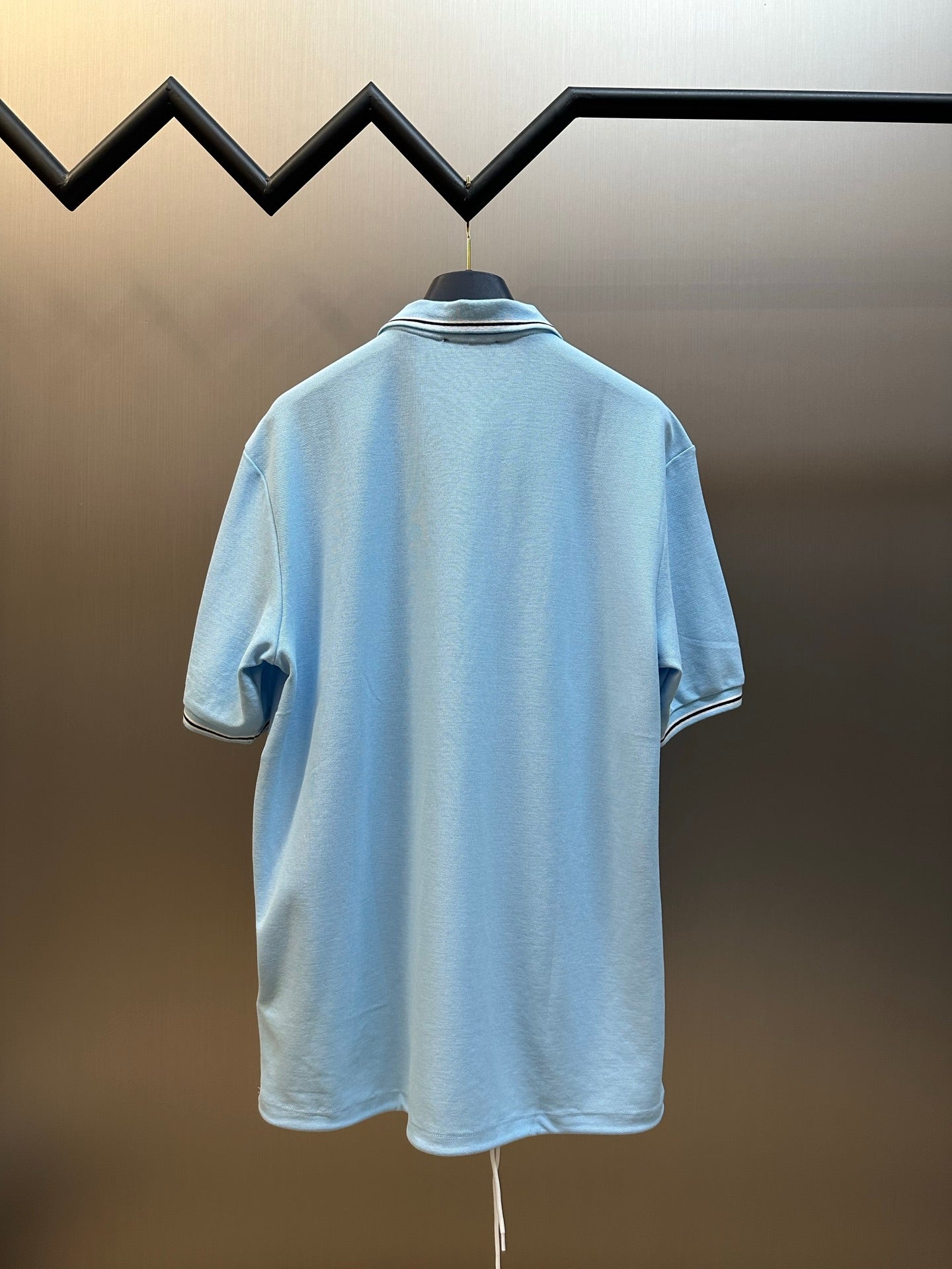 Prada light blue polo shirt back view with striped collar trim