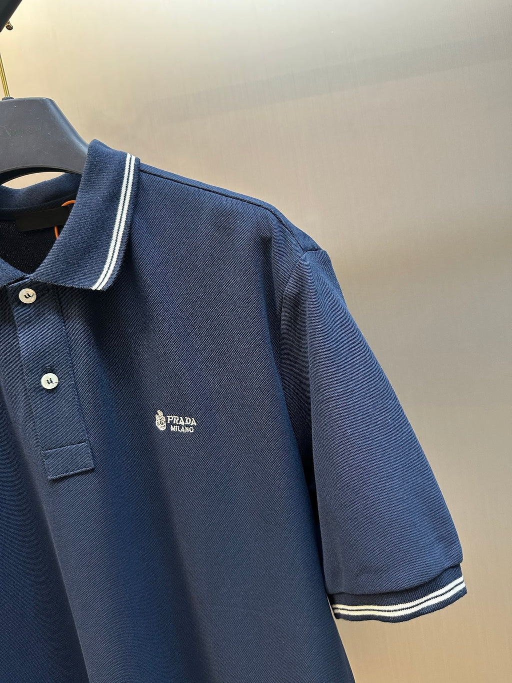 Navy Prada polo shirt with chest logo and contrast stripe trim on sleeves
