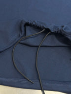 Navy polo shirt with drawstring at hem close-up
