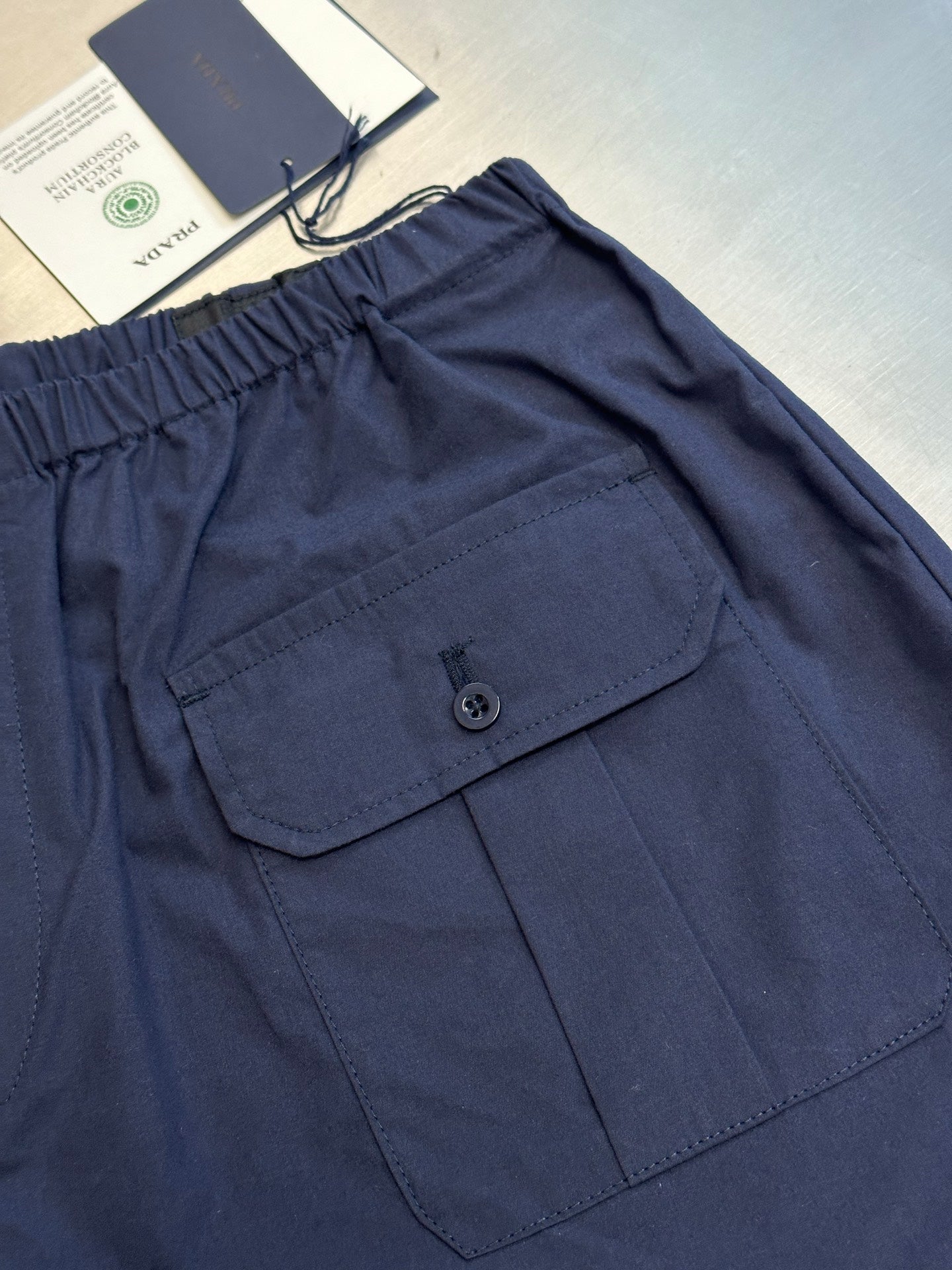 Prada navy shorts with flap pocket and button detail
