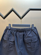 Prada navy shorts with elastic waist, cargo pockets, and button placket