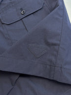 Prada navy shorts with triangular logo patch and stitched pocket seam