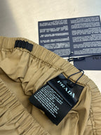 Beige cargo shorts with elastic waistband, belt loops, and hang tags attached.