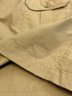 Beige cargo shorts with stitched patch detail near the hem and side seam.