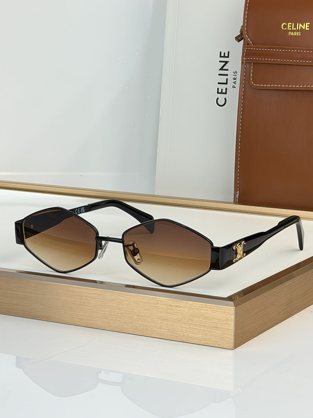 Celine sunglasses with black frame and brown gradient lenses, gold-tone temples